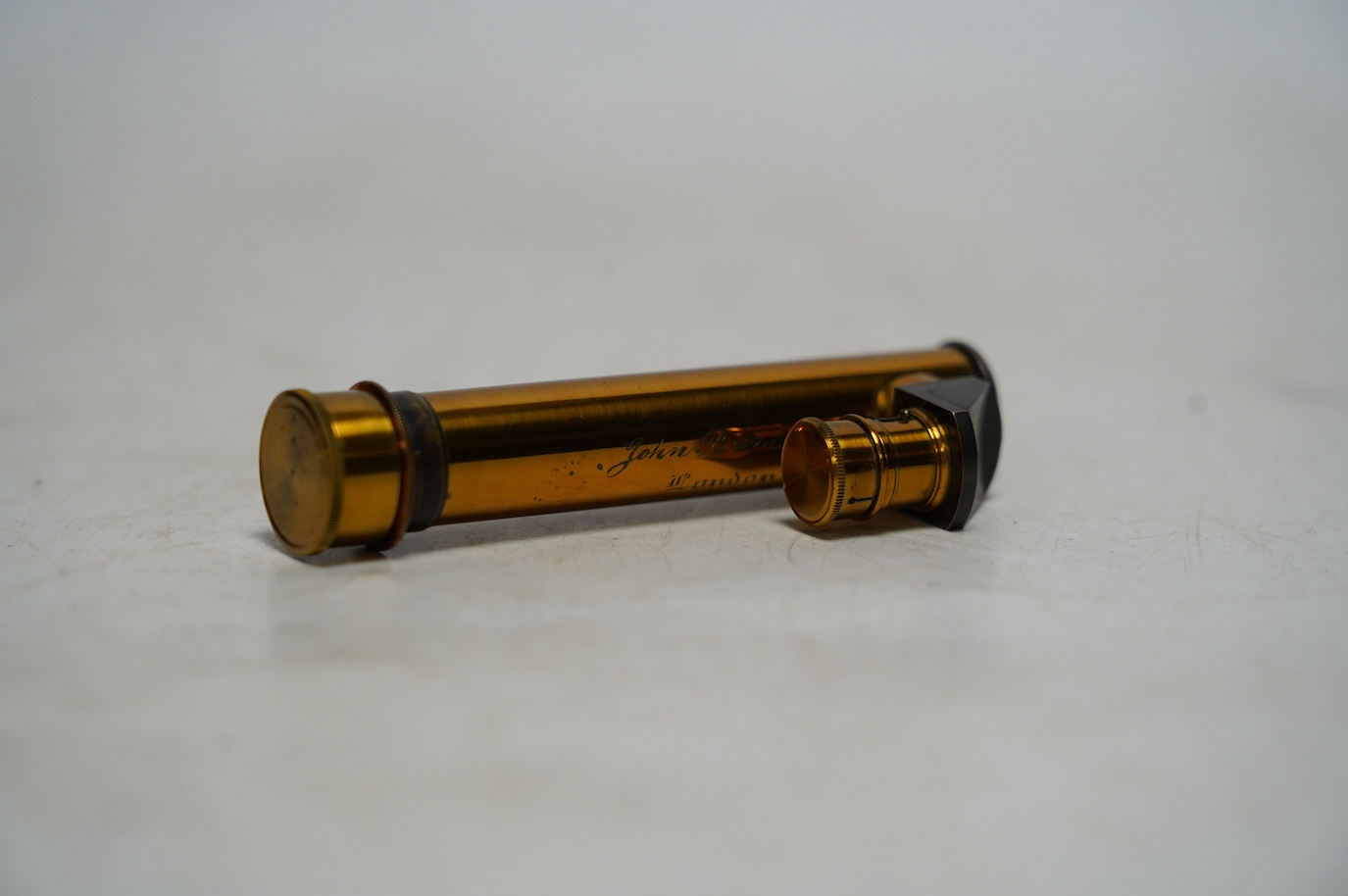 A late 19th century cased brass pocket spectroscope, engraved ‘John Browning London’ 8.5cm. Condition - fair